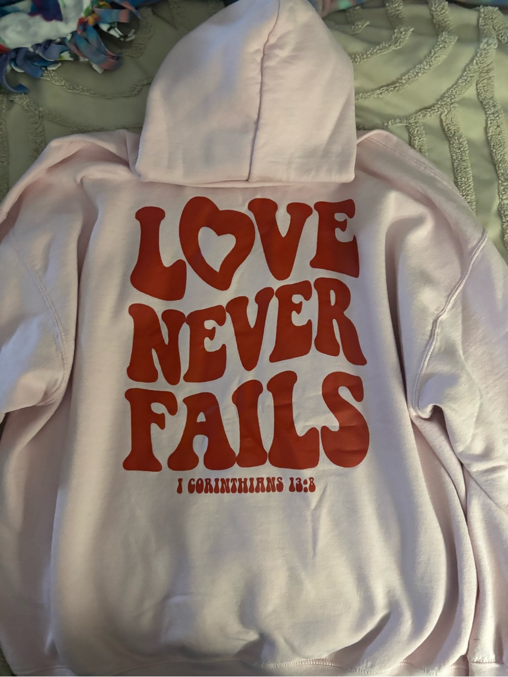 Gildan Pink Hoodie with Bold Red "Love Never Fails" Graphic